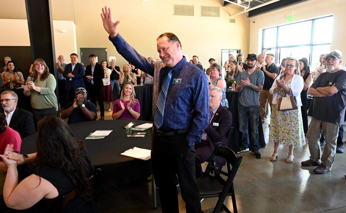 Aslan Meade, director of strategic alliances for the Thurston EDC acknowledges the public applause for his work during the grand opening of the new Agriculture Innovation Park in Tenino drew a large crowd of well wishers on May 29, 2025. The event featured self-guided tours and speakers and concluding with the unveiling of a multi-ton, hand carved sign crafted out of local sandstone by Daniel Miller with the Tenino Stone Carvers.