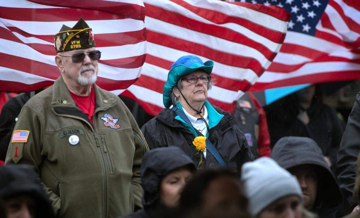 Judy Smith of Olympia holds a yellow rose in remembrance of her late husband, Air Force veteran Michael D. Smith, during the dedication and unveiling of the new Gold Star Families Memorial Monument at the Lacey Civic Plaza on Friday, March 31.