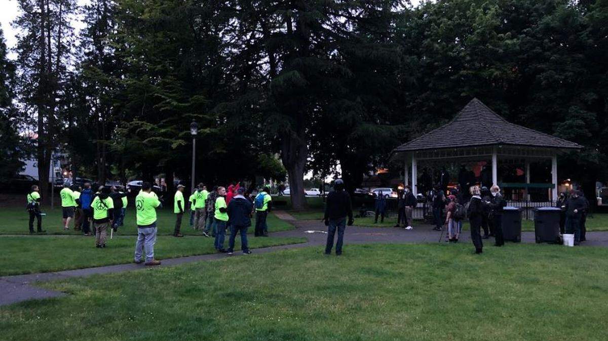 “Peacekeepers” wearing yellow shirts approach protesters in Sylvester Park in downtown Olympia June 12.