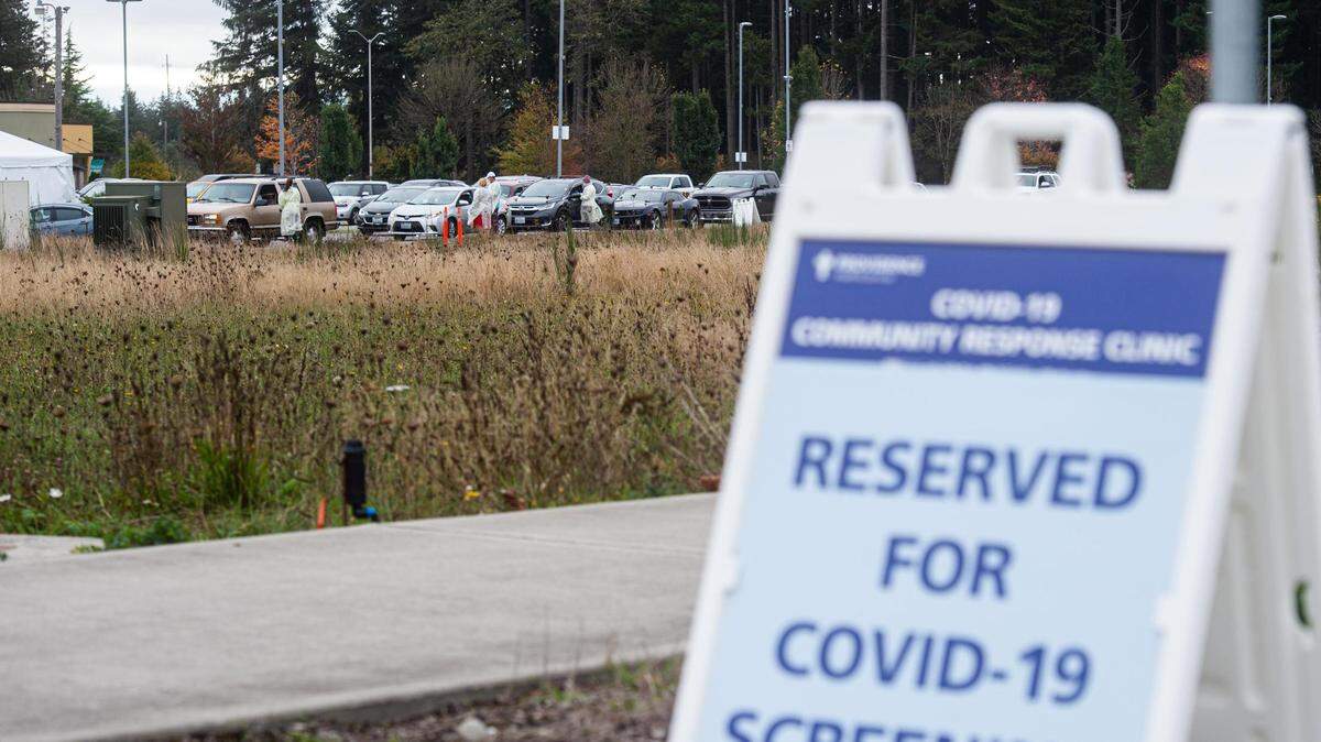 Cars line up as people wait for a drive-thru COVID-19 test at Providence Hawks Prairie Family Medicine in Lacey, Wash., on Friday, Oct. 16, 2020.