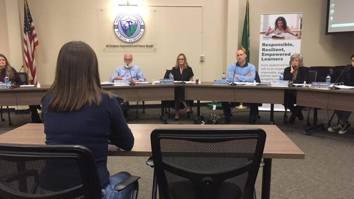 Parent Stephanie Scott addresses the North Thurston Public Schools board during public comment Tuesday night. From left to right are board members Graeme Sackrison, Gretchen Maliska, Dave Newkirk and Superintendent Debra Clemens.