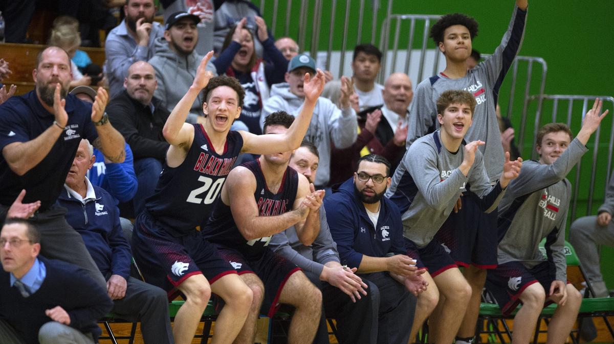The Black Hills Wolves bench celebrates a three-point shot during Friday night’s boys basketball game against their crosstown rival Tumwater T-Birds at Tumwater High School Jan. 18, 2019.