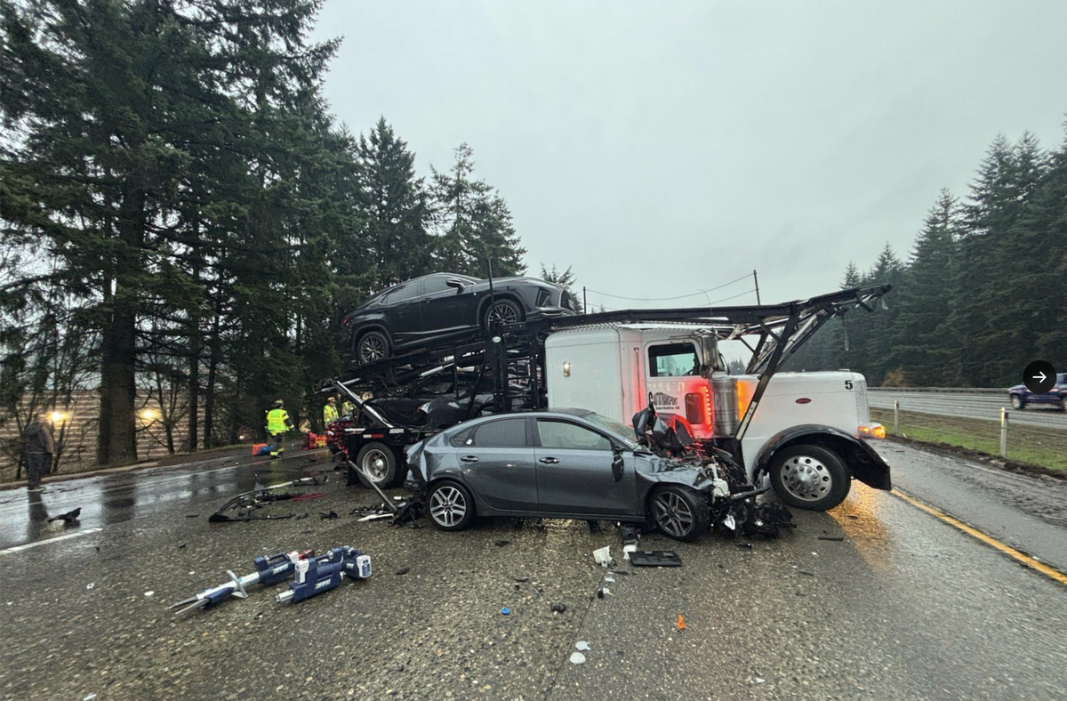 A semi-truck carrying vehicles jackknifed on Interstate 5 in Lacey Thursday morning, resulting in a multi-car wreck and a miles-long traffic back up.