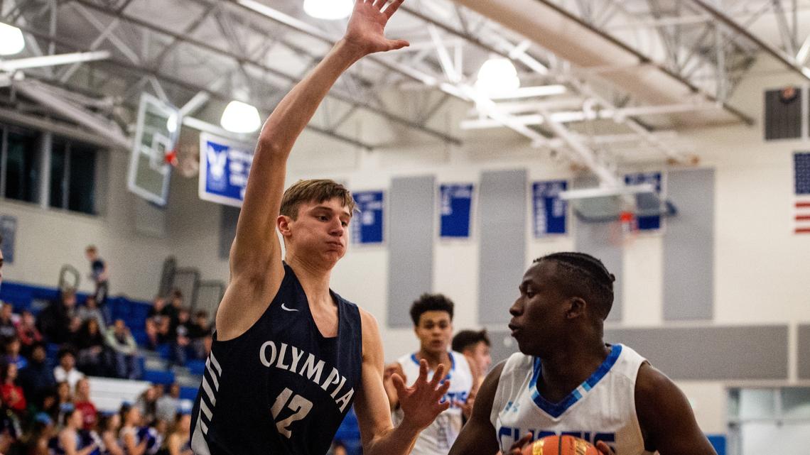 Olympia’s Jackson Grant (12) plays defense during the first quarter. Curtis played Olympia in a basketball game at Curtis High School in Tacoma, Wash., on Friday, Dec. 14, 2018.