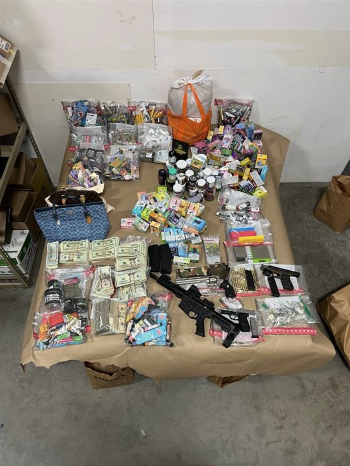 A haul of illicit drugs, weapons and other items that law enforcement recovered from a Lacey home Wednesday. The Thurston County Narcotics Task Force and Lacey police arrested five people on suspicion of multiple drug and firearm crimes at the property.