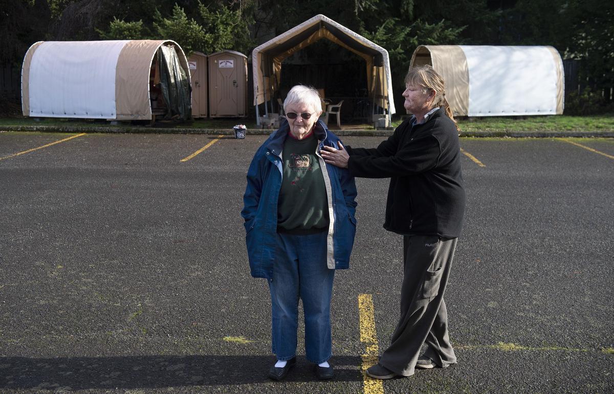 Church volunteer Barb Prentice, left, receives thanks from resident and friend Vickie (who did not want her last name used) outside huts in the parking lot of the Unitarian Univeralist Church in Eugene, Oregon. “My gratitude and my love for the women in the church... I would never forget it,” Vickie says.
