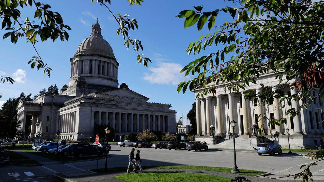 The afternoon sun illuminates the Legislative Building, left, and the Insurance Building, right, at the Capitol in Olympia, Wash., on Oct. 9, 2018.