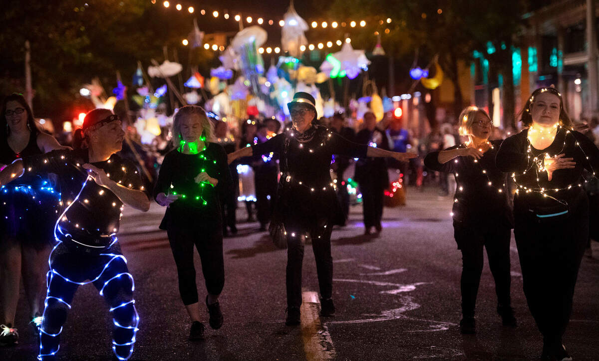 Samba Olywa dancers lead the Luminary Procession down Capitol Way during the Fall Arts Walk in downtown Olympia, Washington, on Friday, Oct. 7, 2022.