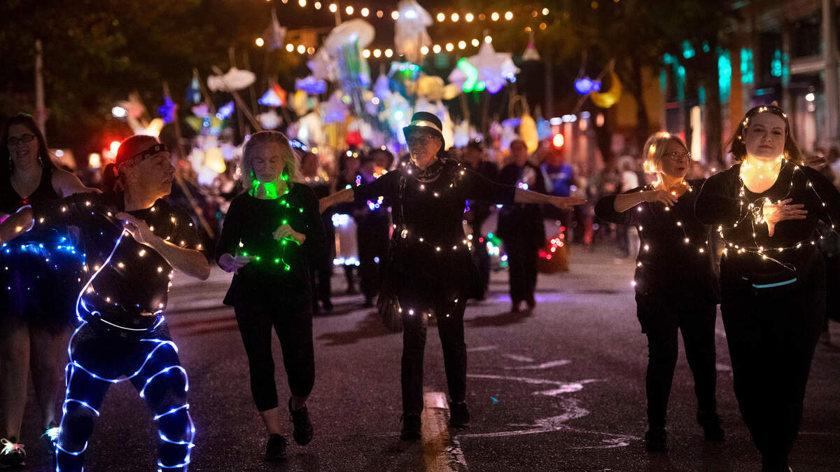 Samba Olywa dancers lead the Luminary Procession down Capitol Way during the Fall Arts Walk in downtown Olympia, Washington, on Friday, Oct. 7, 2022.