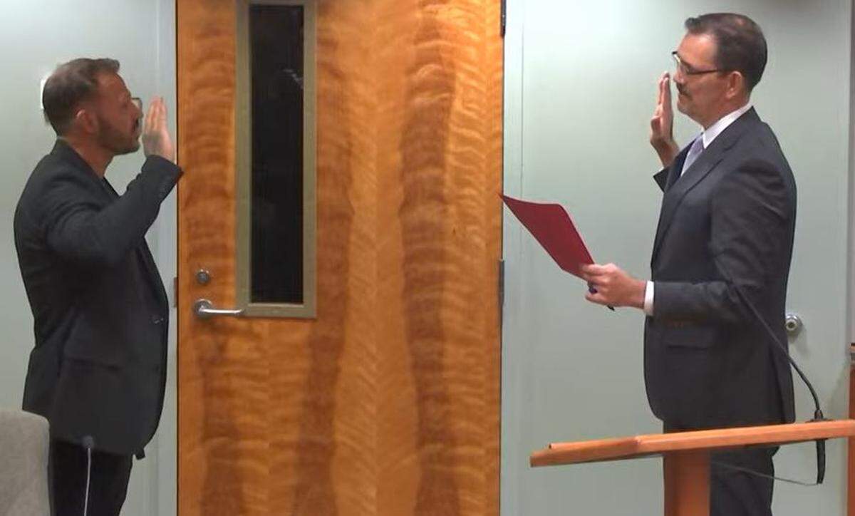 Nic Dunning, the newest member of Lacey City Council, takes the oath of office and is sworn in by City Attorney Dave Schneider.