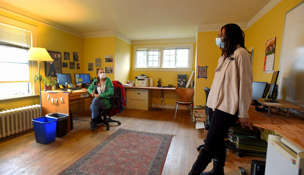 New executive director Olivia Hickerson (R) chats with Alanna Barros-Dotson, operations director for SideWalk, a local non-profit that helps rehouse people experiencing homelessness.The organization will be holding a relaunch event for the public on April 27 from 3-5:30PM at their offices located at 1139 5th Ave. SE in Olympia. Photo taken April 10, 2023