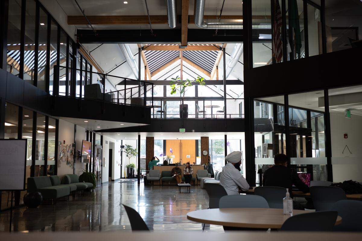 Members of the public wait to be served inside the lobby of The Atrium, Thurston County’s administrative headquarters in Olympia, on Friday, Sept. 19, 2025. The Atrium, located at 3000 Pacific Ave. SE, houses services offered by the Auditor’s Office, Assessor’s Office, Treasurer’s Office, Community Planning and Economic Development Department and more.