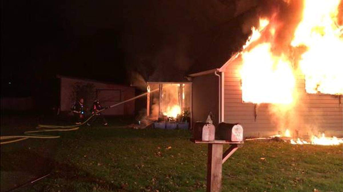 Crews respond to the house fire on the 1100 block of Central Street Northeast on Thursday evening.