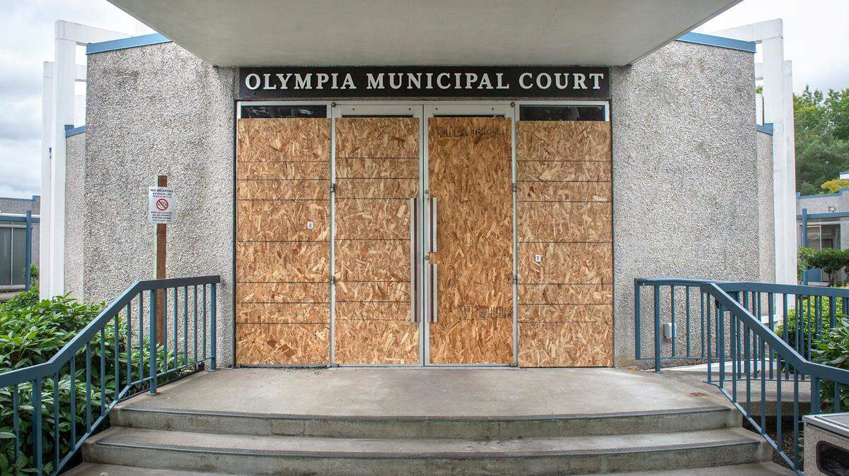 The entry doors to the Olympia Municipal Court building on Plum Street are boarded up after being broken by vandals on Friday night. It is shown on Saturday, July 11, 2020.