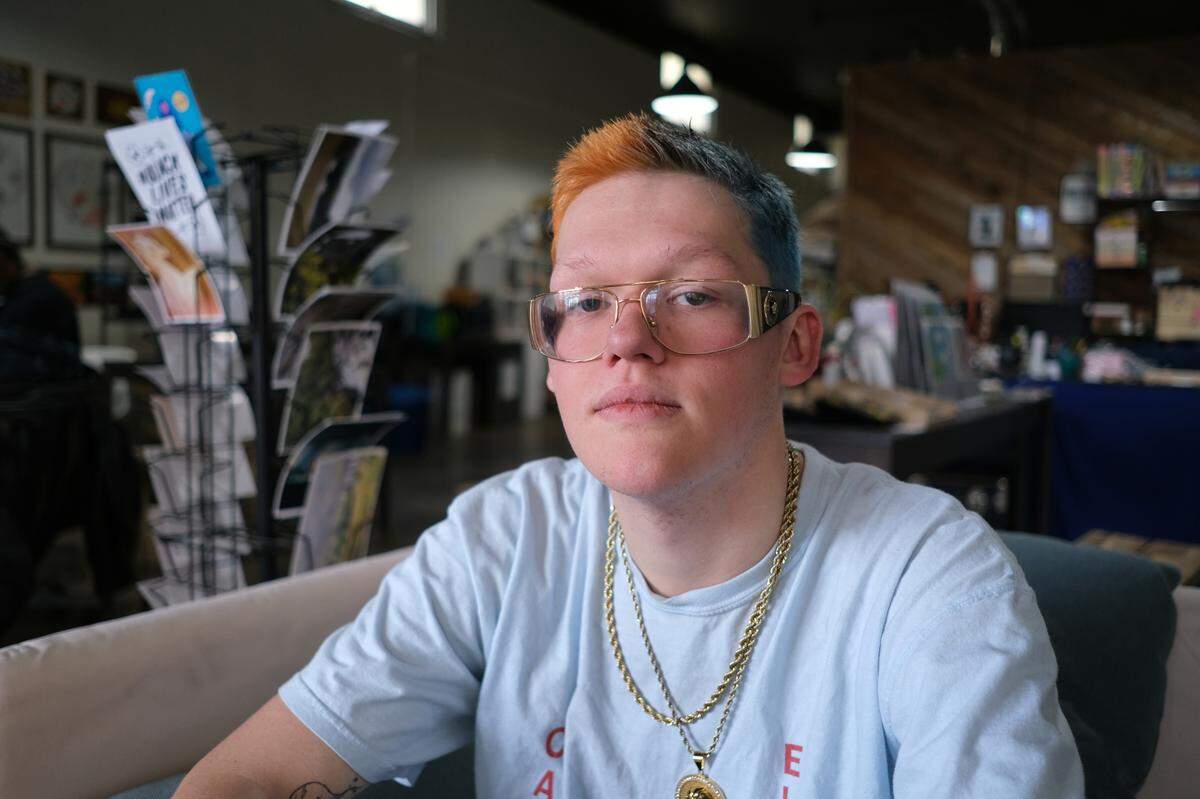 Shaelyn Reed, 23, sits on a couch at Olympia Lamplighters on Jan. 27, 2023. Reed has benefited from the peer support offered by CARE Olympia, a non-profit that helps justice impacted youth reintegrate into the community.