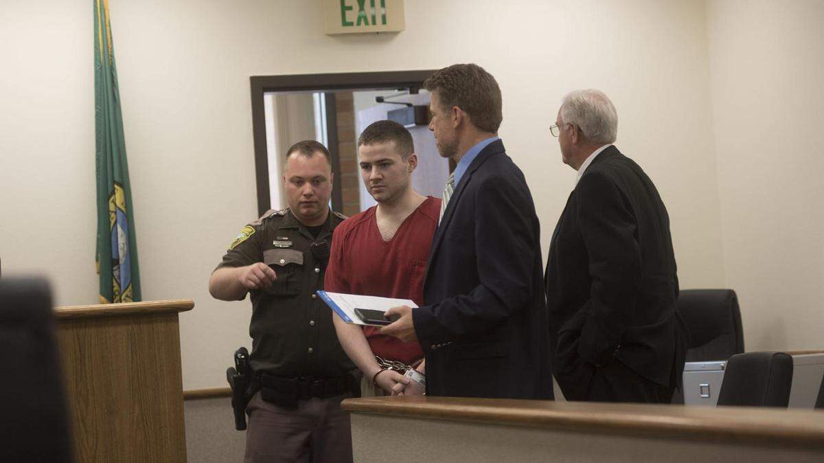 Jonathon Adamson is led into Lewis County Superior Court for a June hearing.