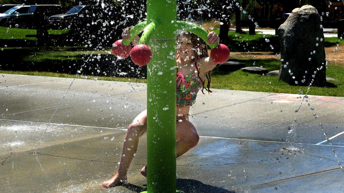 Enjoying a a cool visit on a very warm Wednesday at Olympia’s Lions Park with mom Shannon and younger sister Katherine ten year-old Lizzy Jones tries out one of the fun water features in the newly-opened Sprayground area. The park is located at 800 Wilson Street SE and the Sprayground hours will run 11 a.m. - 7 p.m. seasonally.