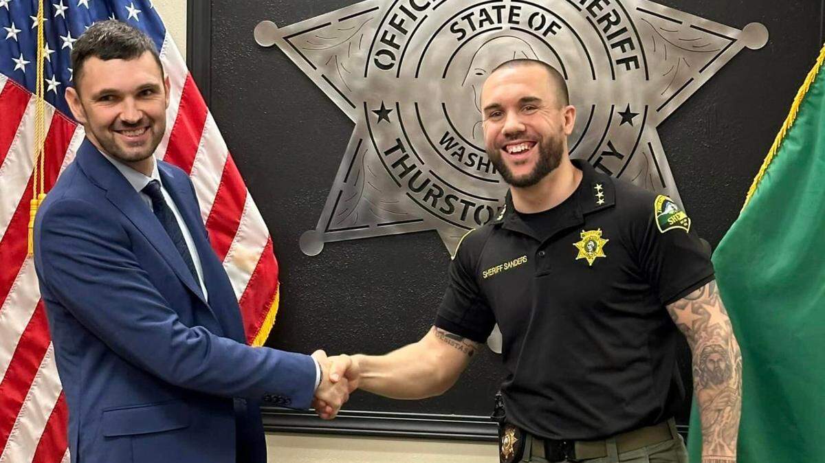 Lateral Patrol Deputy Christopher Burbank is pictured here with Thurston County Sheriff Derek Sanders.