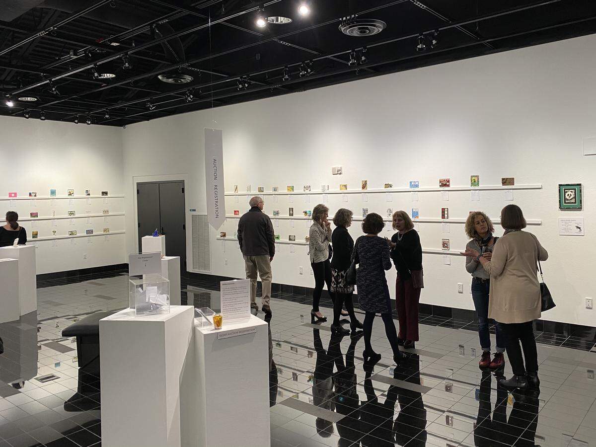 Visitors check out the “Power Tools” Fine Art Postcard Exhibition at the newly renamed Leonor R. Fuller Gallery inside the Minnaert Center for the Arts at SPSCC. The art is being auctioned off, with the silent bidding wrapping up before the closing reception Friday night.