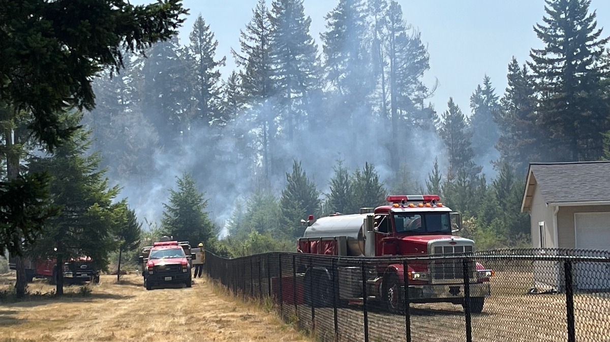 A water tank gets ready to deploy as firefighters work to contain and put out the McEwan fire north of Shelton on Wednesday afternoon.