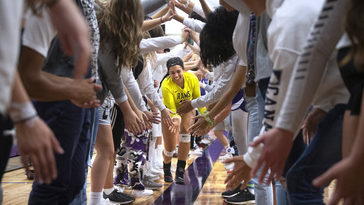 North Thurston junior libero Lauren Porter is welcomed by a tunnel of students as the Ram starters are introduced before their crosstown rivalry match against the Timberline Blazers at North Thurston High School in Lacey on Thursday, Sept 27, 2018.