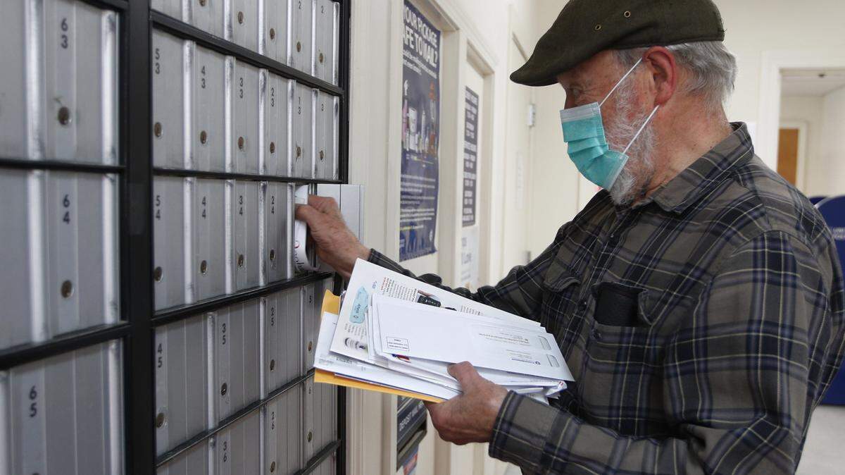 Vaino Kola picks up his mail in Maine. The U.S. Postal Service announced sweeping changes in the face of internal financial struggles.