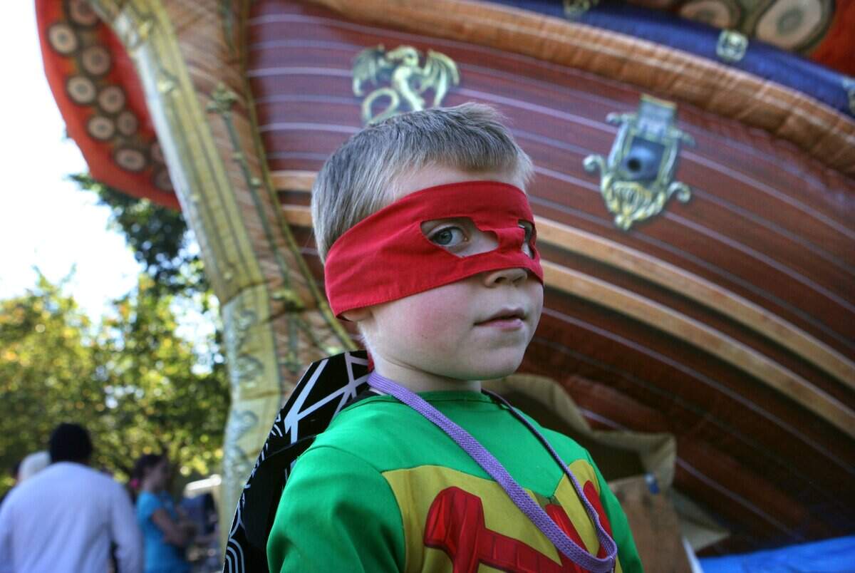 Damon McDermitt of Lacey prowls the games and bounce houses in his Ninja Turtle costume during the 2012 Lacey Children’s Day celebration at Huntamer Park in Lacey. The celebration returns Saturday.