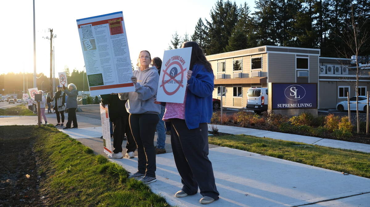 About three dozen people protested against local sex offender housing outside a Supreme Living facility at 6622 Martin Way East near Lacey on Friday, Feb. 10.