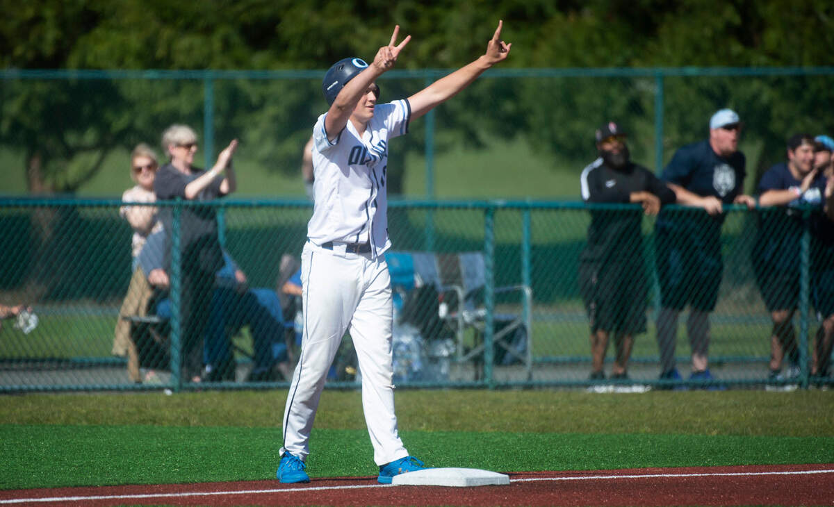 Olympia’s Sax Matson celebrates teammate Gabe Downing’s ground-rule double during the Bears 6-0 victory over Issaquah in the quarterfinal round of the 4A state baseball tournament at the Regional Athletic Complex in Lacey, Washington, on Saturday, May 22, 2022.