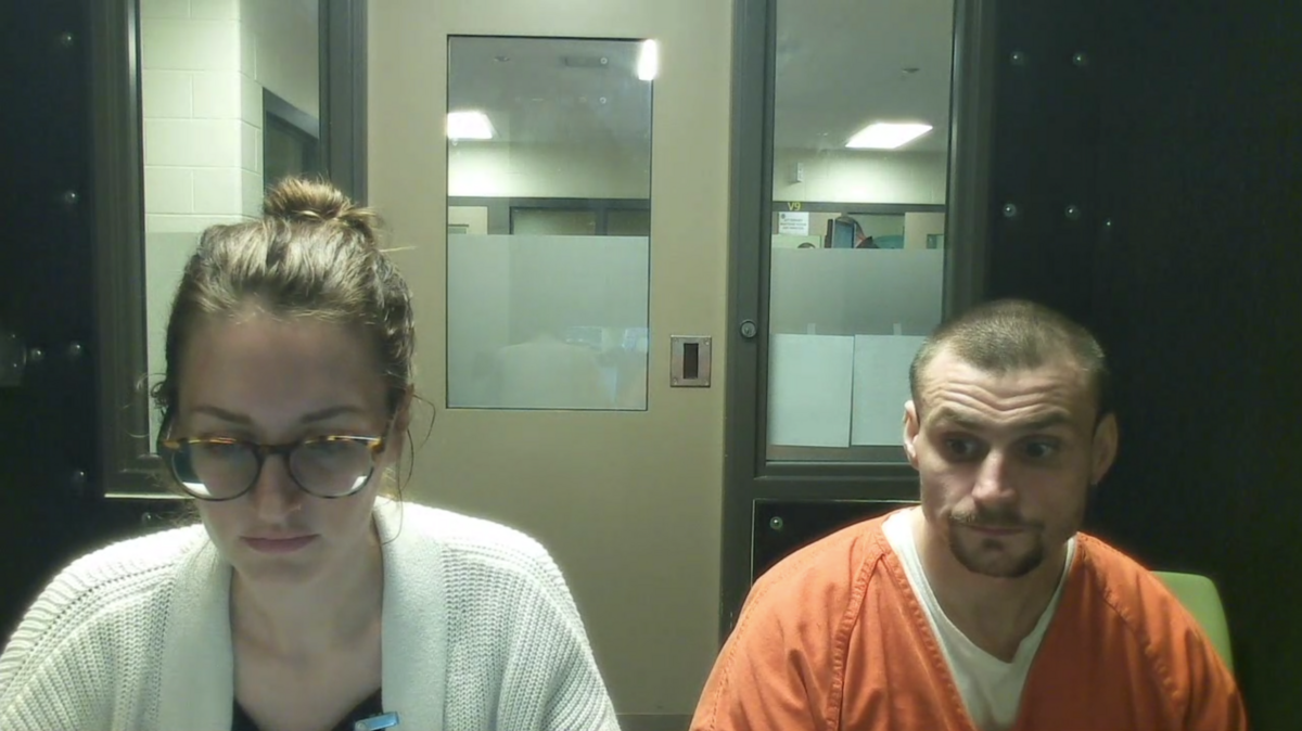 Christopher Edward Snyder, 31, (right) sits next to defense attorney Diana Wildland (left) in a booth at the Thurston County jail on Monday, Oct. 21, 2024.