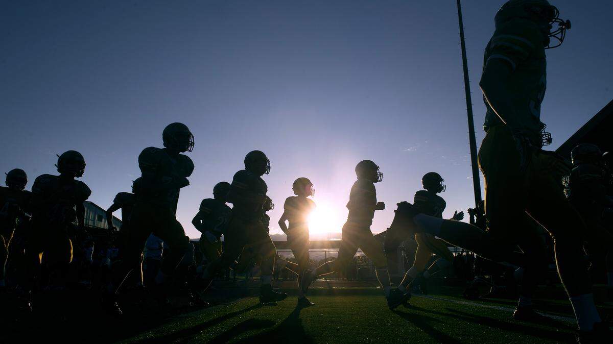 Tumwater players enter the field for Friday night’s season-opening football game against Timberline at Tumwater District Stadium on Sept. 6, 2019.