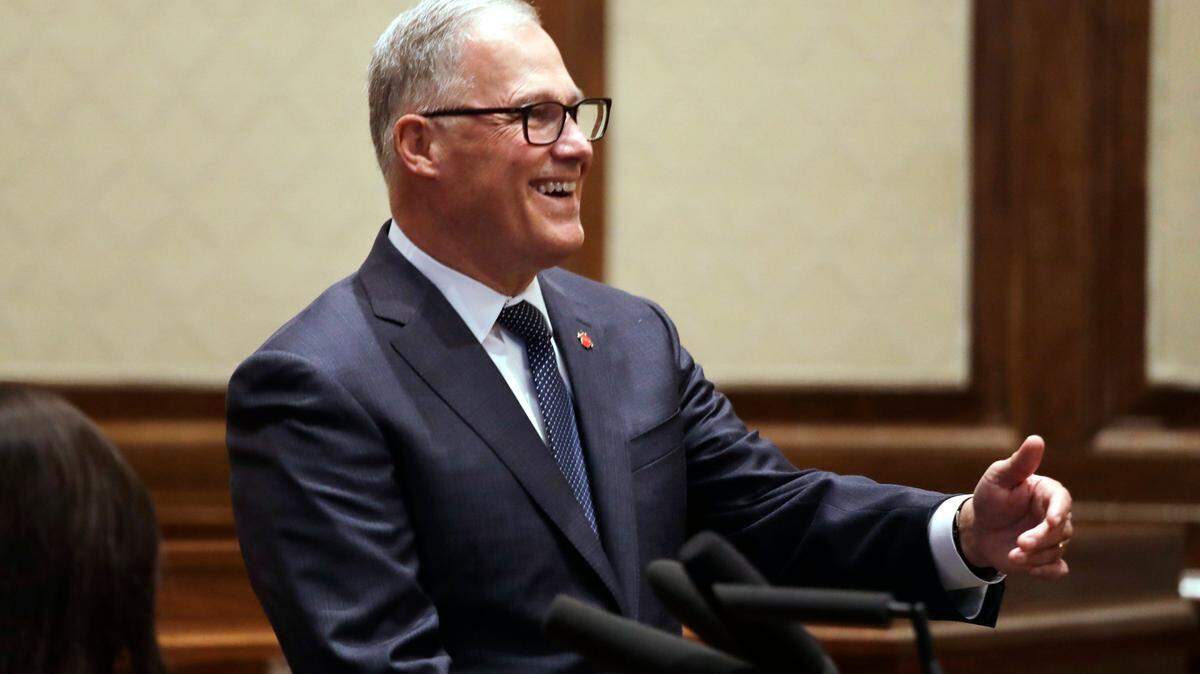Gov. Jay Inslee smiles after he introduced Whatcom County Superior Court Judge Raquel Montoya-Lewis as the newest member of the state Supreme Court Wednesday. Inslee is getting hip replacement surgery next week.