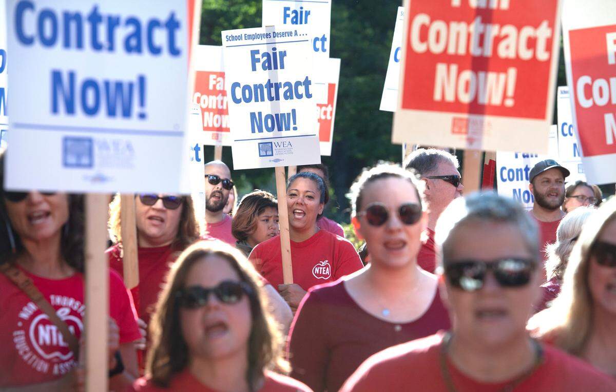 Jennifer Cariaso, a middle and high school teacher at Summit Virtual Academy joins about 300 fellow teachers and supporters during a picket and march by members of the North Thurston Education Association outside the North Thurston Public Schools administration building in Lacey, Washington on Thursday, Aug. 25, 2022.