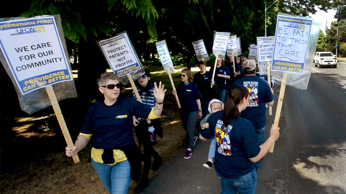 Nurses and staff at Providence St. Peter Hospital in Olympia hold an informational picket in June