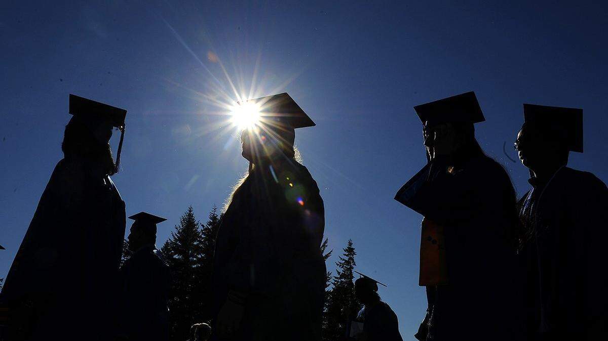 Graduates make their way from the gymnasium for their traditional walk to the athletic fields to begin the 2015 Commencement exercises at South Puget Sound Community College.