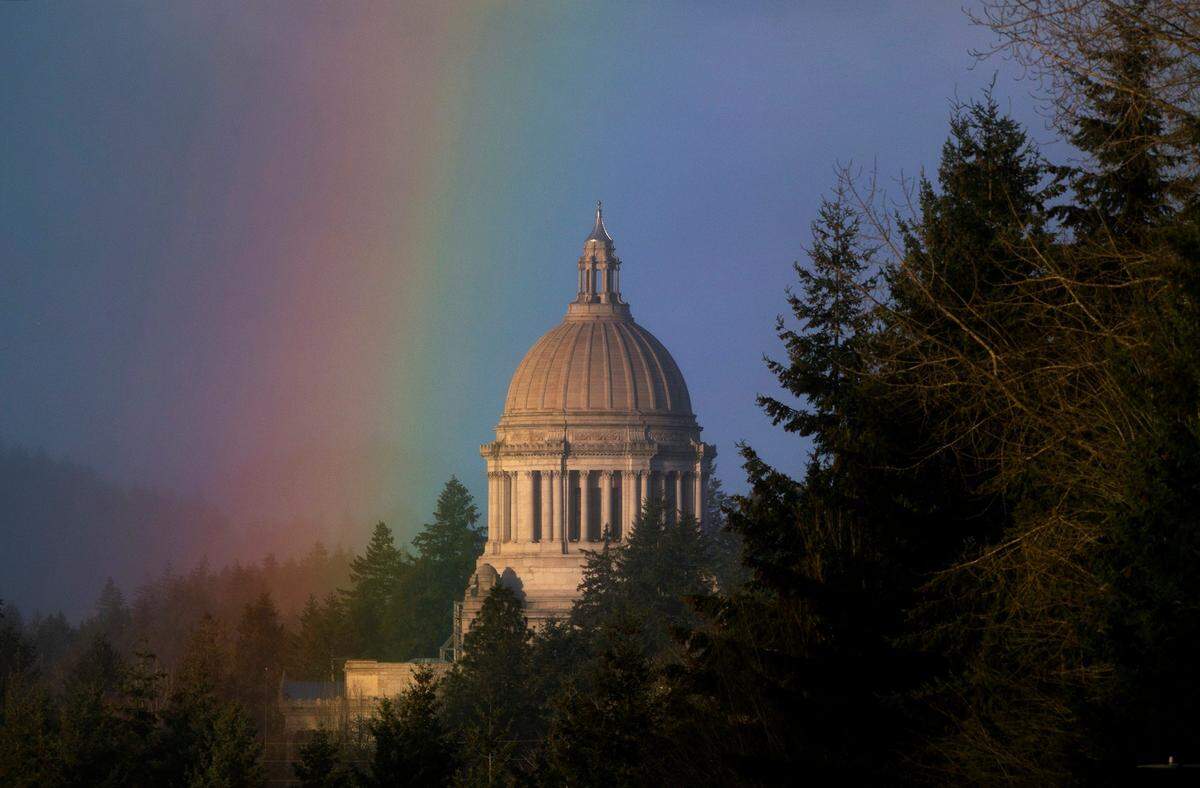 A rainbow shines over the Capitol in Olympia during a break in the rain on Wednesday morning, Jan. 13, 2021.