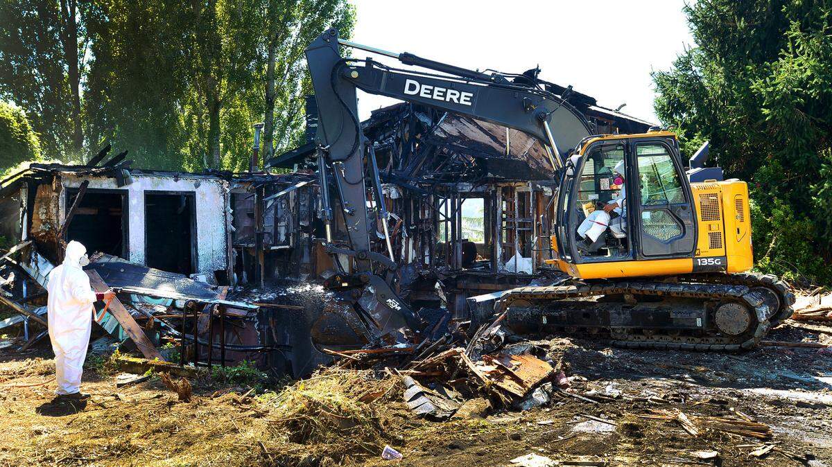 A crew from Federal Way-based Luna Homes NW demolishes a home at 519 Puget St. NE on Tuesday, Aug. 23, that was gutted by fire three years ago. That same evening the Olympia City Council voted on an ordinance to establish an abandoned properties registration program.