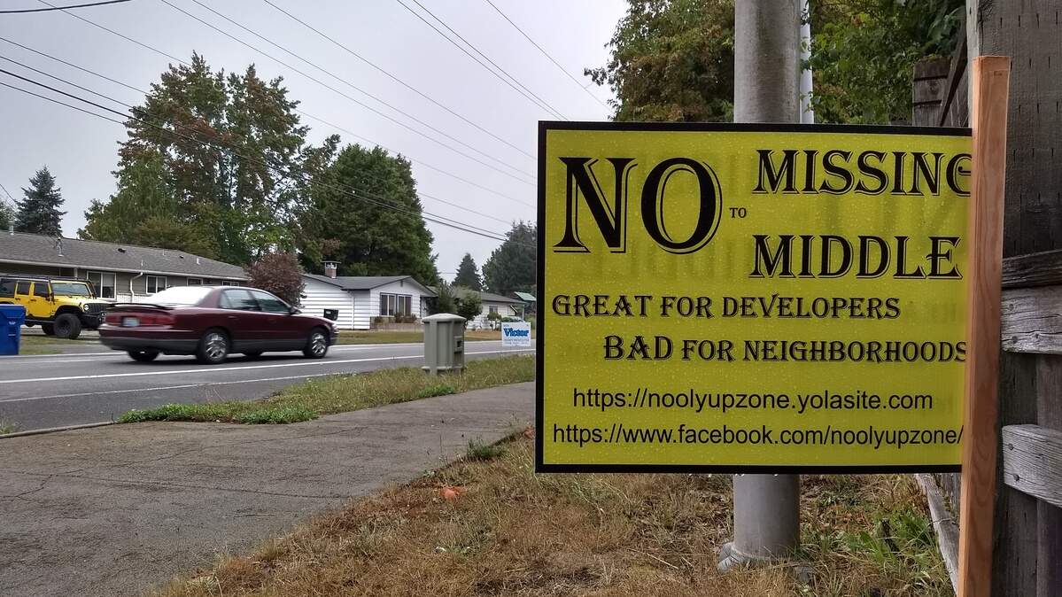 Drivers pass a yard sign against the “missing middle” zoning-related changes on Boulevard Road Southeast in Olympia.