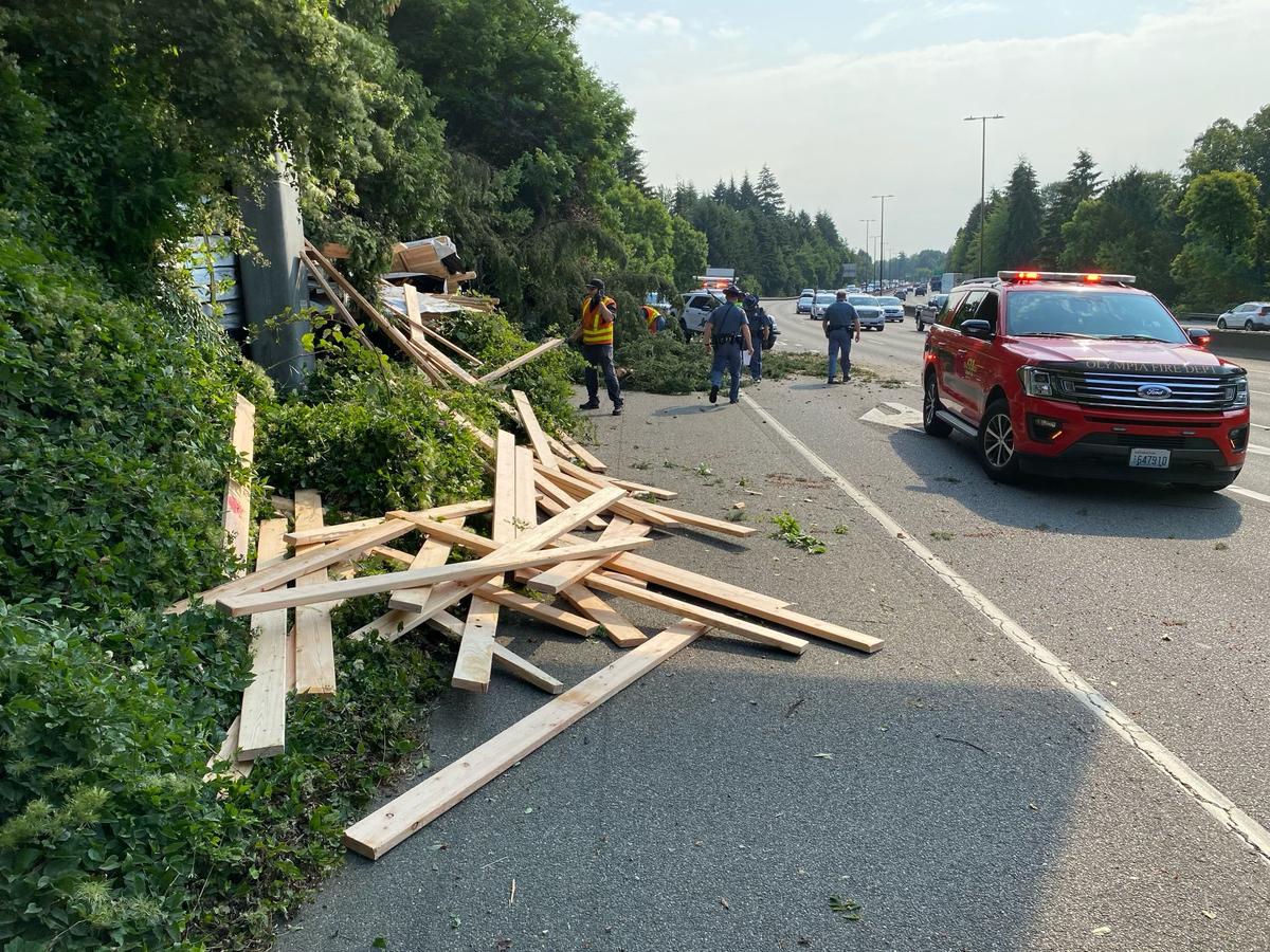 The right lane of Exit 105 on southbound I-5 into Olympia was still blocked as of 12:15 p.m. Friday after a flatbed truck hauling lumber left the road and struck a tree.&nbsp;