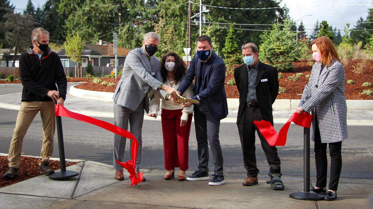 Thurston County Commissioners Tye Menser and Carolina Mejia, along with City of Lacey Mayor Andy Ryder and Transportation Improvement Board Executive Director Ashley Probart, cut a red ribbon at the roundabout connecting Mullen and Carpenter Roads on Friday, Oct. 1, 2021. The officials celebrated the completion of a two-year project to improve Mullen Road.