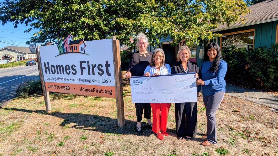 Stacie Belman, Resource Development Committee Chair at Homes First ; Trudy Soucoup, CEO at Homes First; Vikki Strand, Community Relations Officer at Sound Credit Union ; and Denise Parker, Community Relations Officer at Sound Credit Union, hold a check for $17,000.