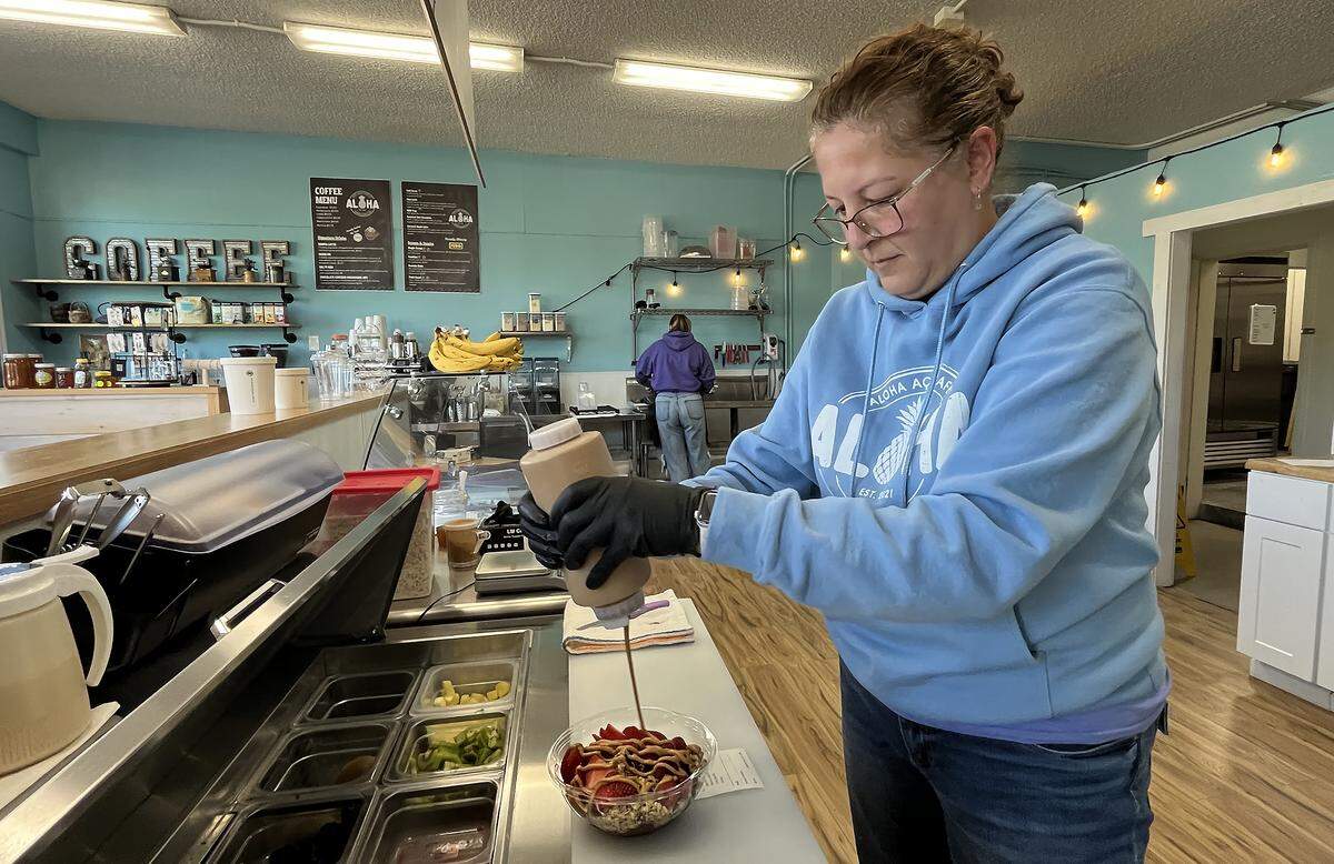 Working at her west Olympia shop on Oct. 15, Aloha Acai Cafe owner Laura Alden prepares a chocolate lover’s açaí bowl, created with cacao sorbet topped with granola, raspberries, strawberries, Nutella & cacao nibs.