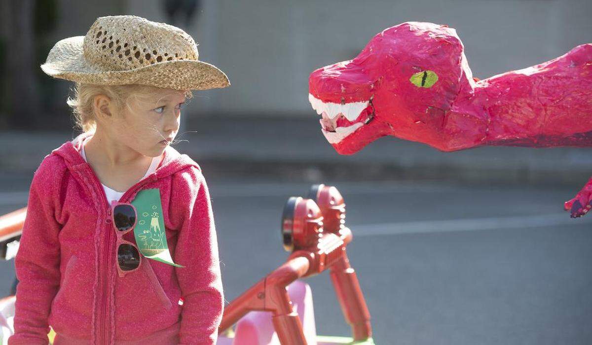 Ava Bryant, 5, of Olympia, keeps a close eye on her Tyrannosaurus Rex float during the 89th annual Pet Parade in downtown Olympia on Saturday. Ava marched with her chicken, T-Rex.