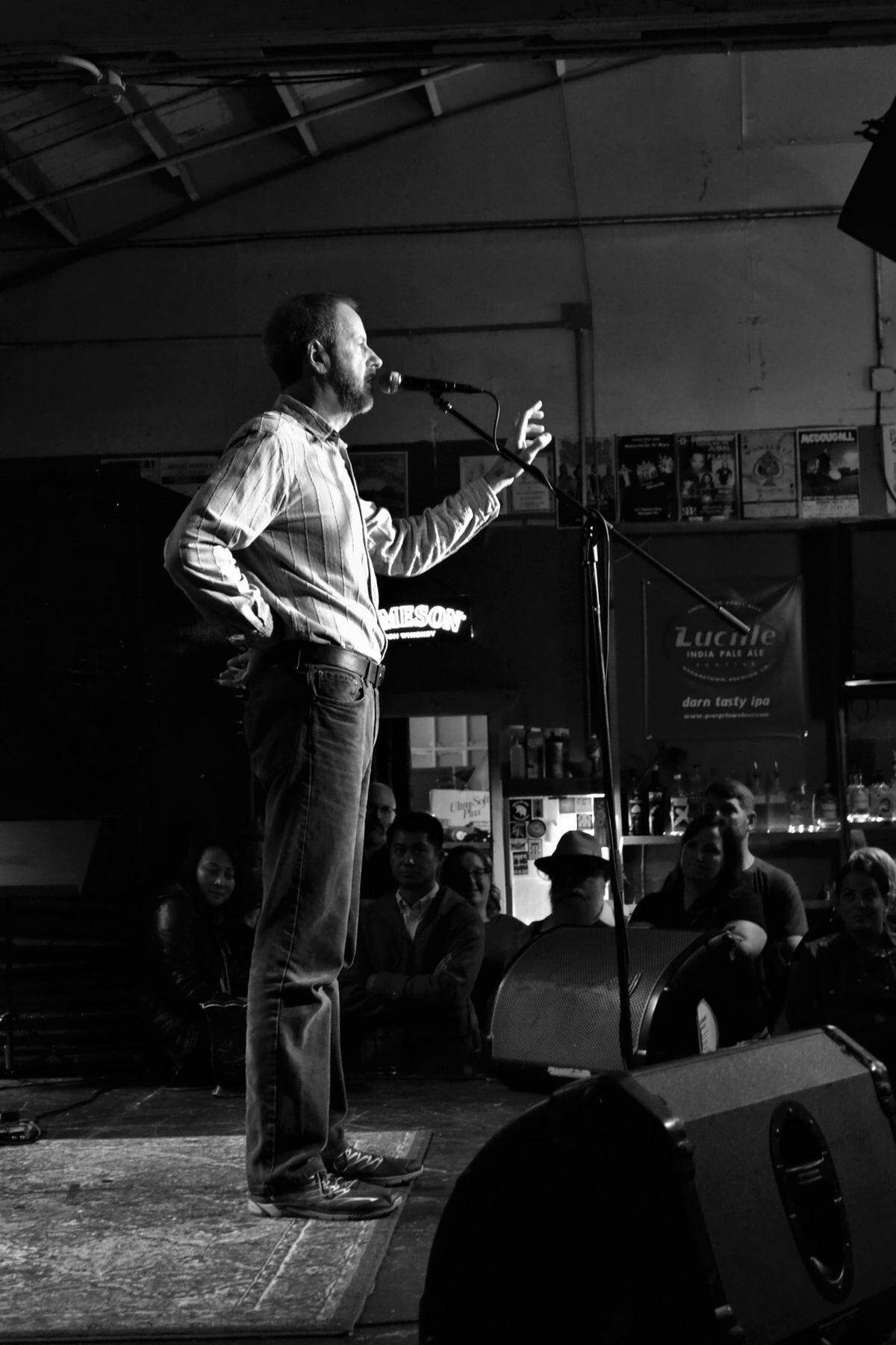 Storyteller David Parker at the mic during the 2018 StoryOly Grand Slam at Rhythm & Rye in downtown Olympia. StoryOly’s monthly events are moving to the 3rd Tuesday of the month at The Brotherhood Lounge.