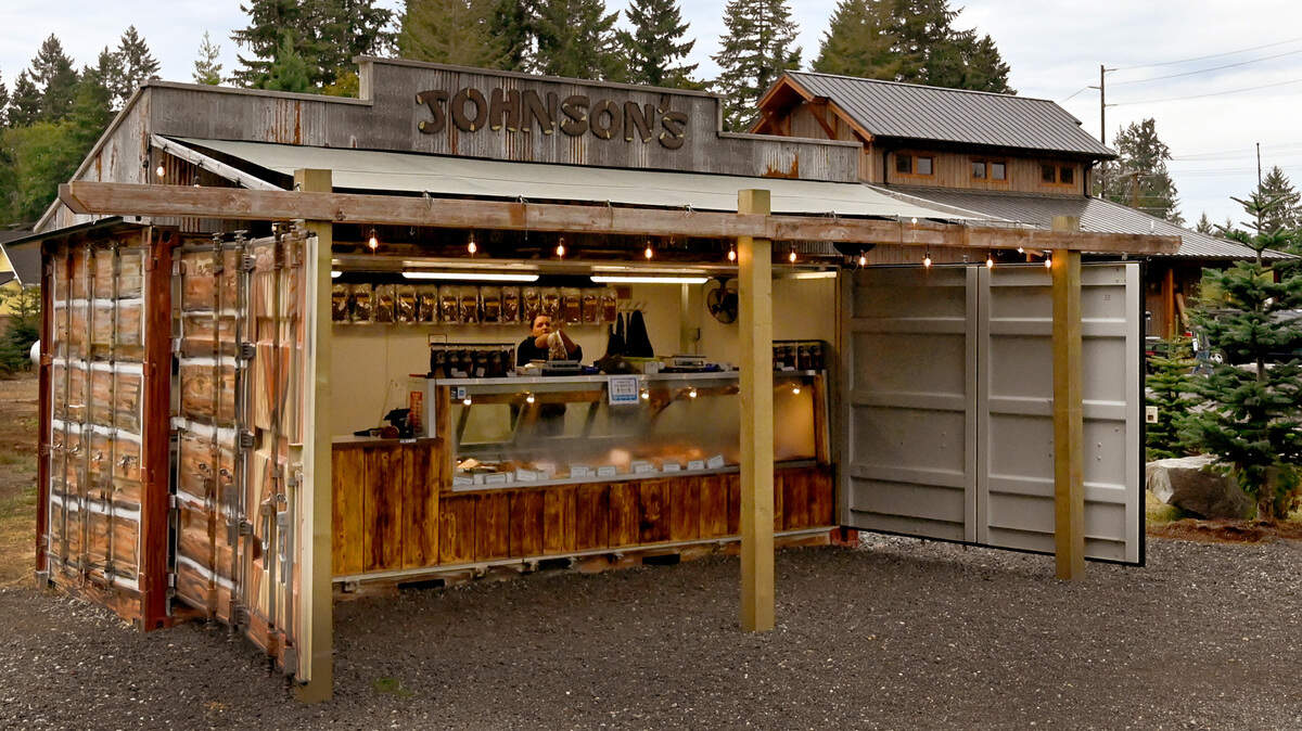 Kelly Creekpaum gets the Johnson Smokehouse & Sausage Kitchen farm stand opened up for business on Sept. 22, 2021. After a devastating 2019 fire, the popular local business has reopened in East Olympia with a small farm. A much larger retail store nears completion at the same location along Rich Road.