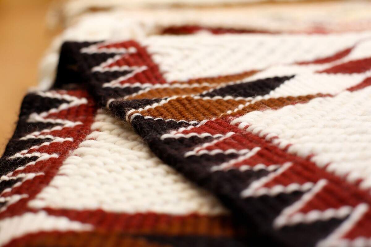 “Of The Earth” is a Coast Salish wool weaving by Susan Pavel.