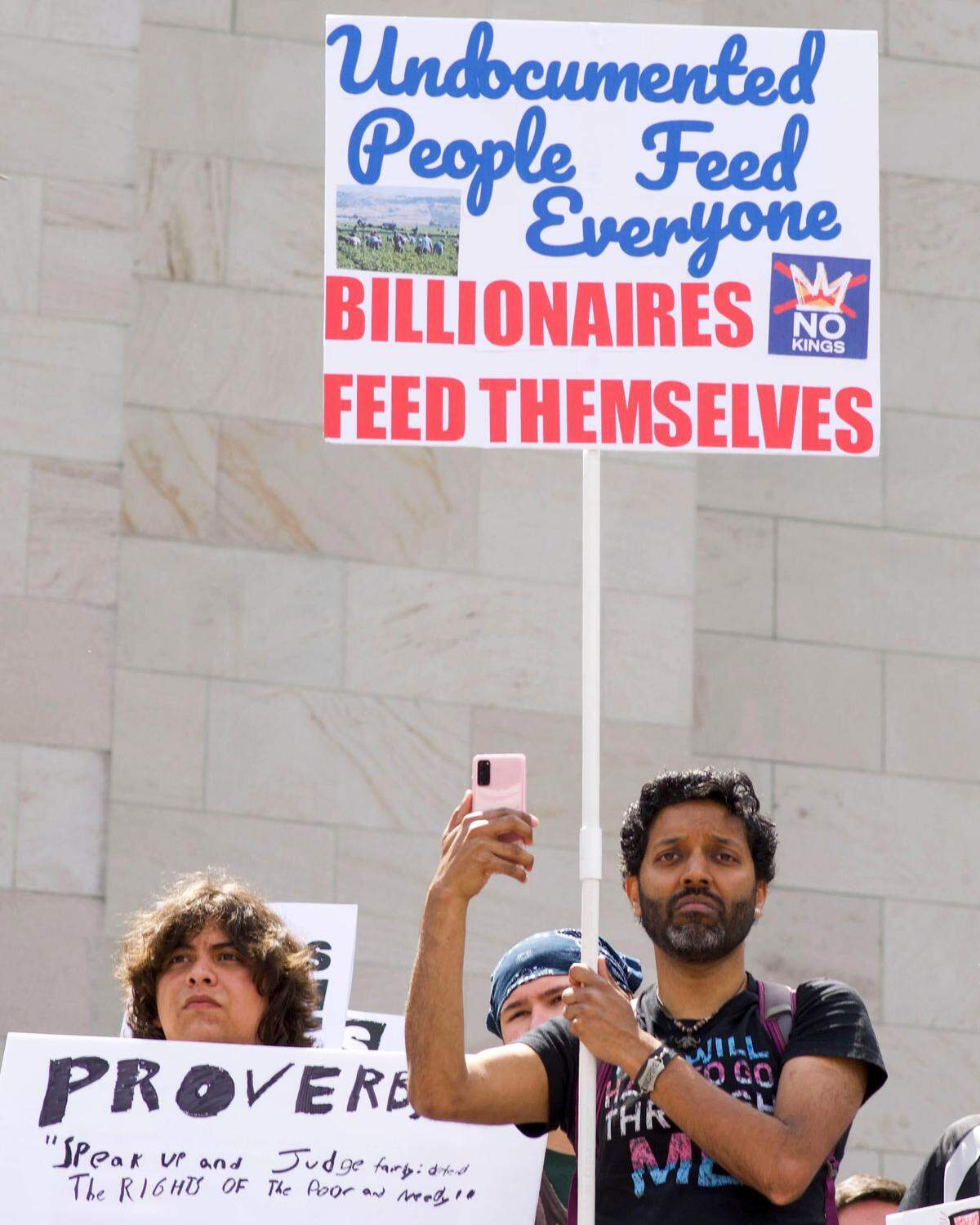 Clever signs were carried by most of the demonstrators gathered on the Capitol Campus in Olympia on Saturday, June 14.