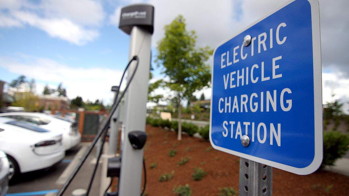 An electric vehicle charging station in a grocery store parking lot.