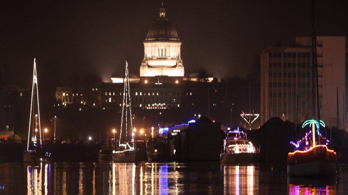 The illuminated Capitol dome shares the night with some of the 14 boats decorated with Christmas lights as the Parade of Lighted Ships rolls out from the Olympia Yacht Club in 2010. 
