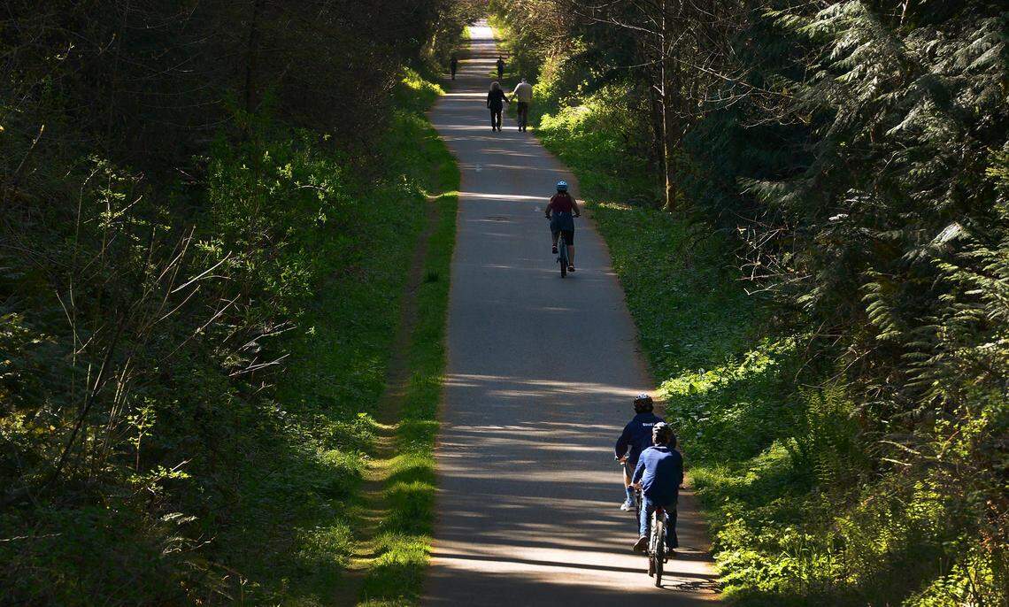Walkers, joggers and cyclists travel the stretch of the Chehalis Western Trail near Woodard Bay Road on April 14.